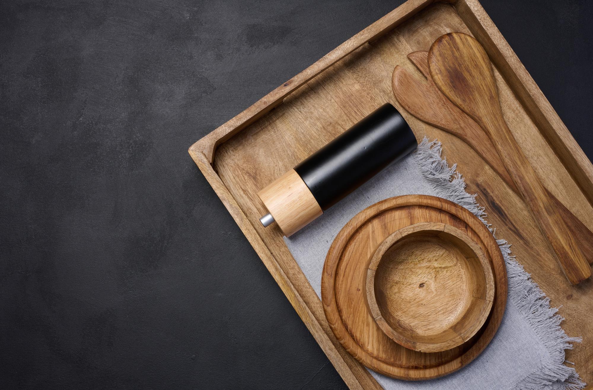 Small tasting plates on dark tray with wooden spoon
